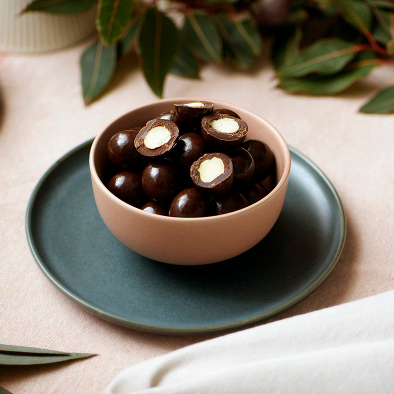 130g bag of vegan dark chocolate coated macadamias, made in Melbourne, Australia
