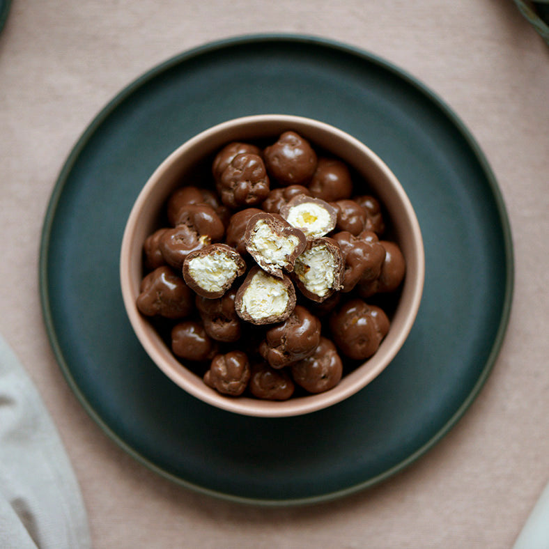 100g pouch of milk chocolate covered caramel popcorn, made in Melbourne, Australia