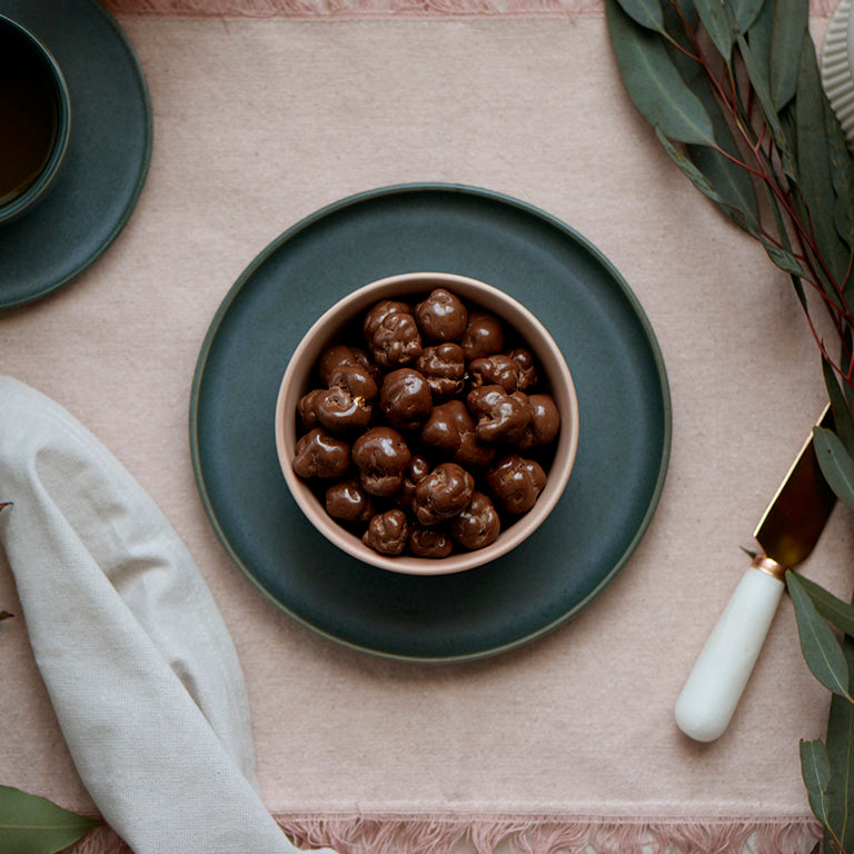 100g pouch of milk chocolate covered caramel popcorn, made in Melbourne, Australia