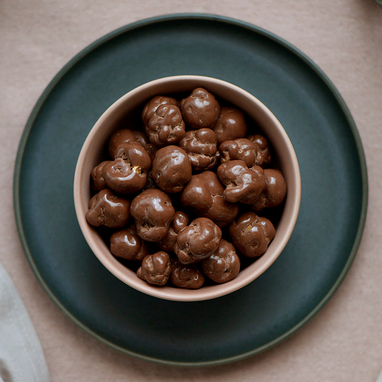 100g pouch of milk chocolate covered caramel popcorn, made in Melbourne, Australia