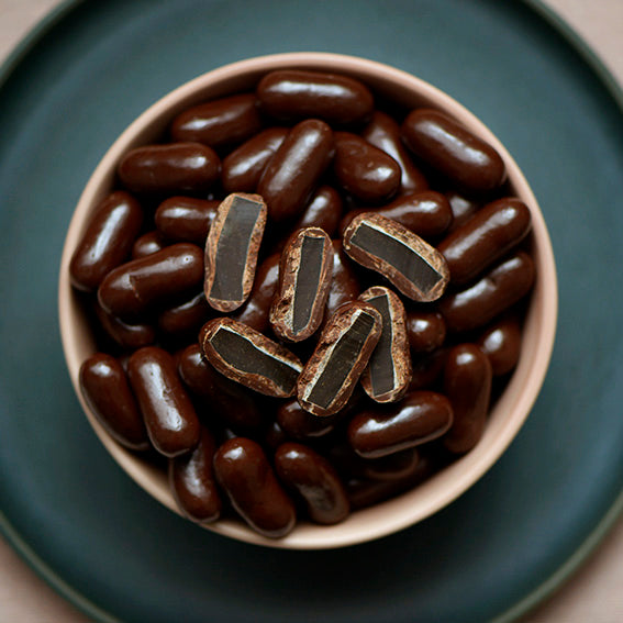 150g bag of dark chocolate coated licorice bullets, made in Melbourne, Australia