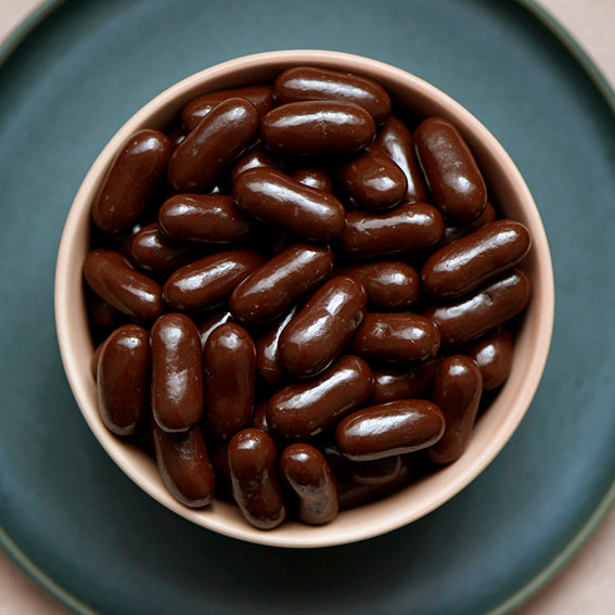 150g bag of dark chocolate coated licorice bullets, made in Melbourne, Australia