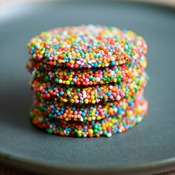 120g pack of milk chocolate discs covered in hundreds and thousands, made in Melbourne, Australia