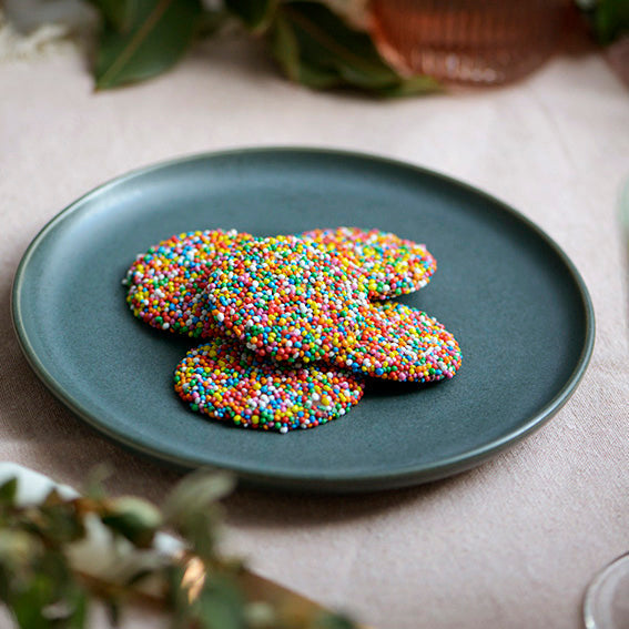 120g pack of milk chocolate discs covered in hundreds and thousands, made in Melbourne, Australia