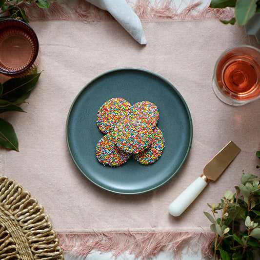 120g pack of milk chocolate discs covered in hundreds and thousands, Australian wholesale