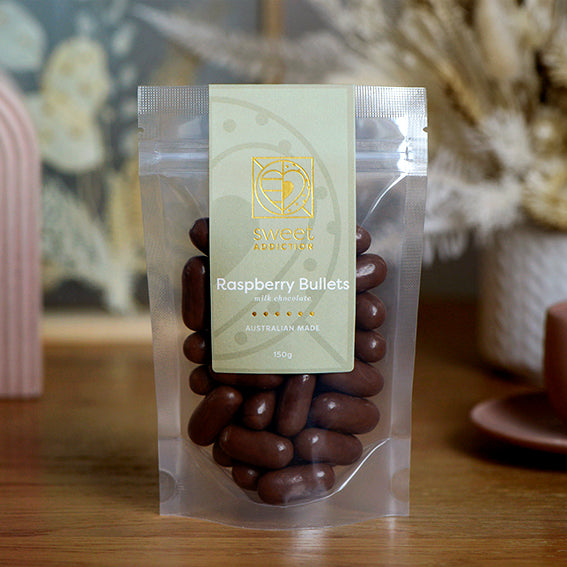 150g bag of milk chocolate coated raspberry bullets, made in Melbourne, Australia