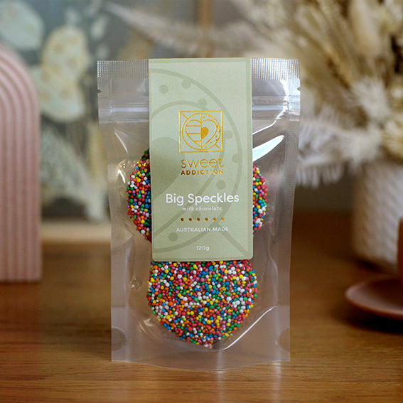 120g pack of milk chocolate discs covered in hundreds and thousands, made in Melbourne, Australia