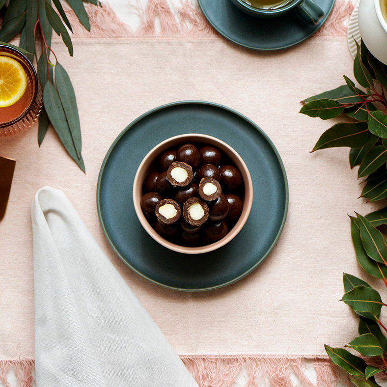 130g bag of vegan dark chocolate coated macadamias, made in Melbourne, Australia