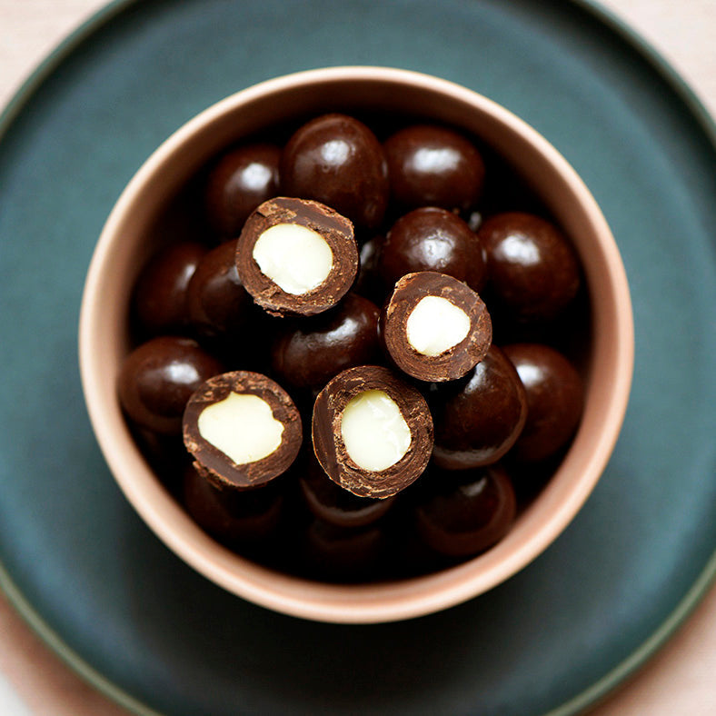 130g bag of vegan dark chocolate coated macadamias, made in Melbourne, Australia