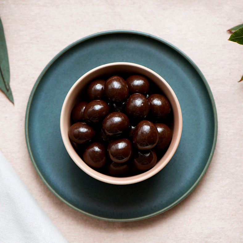 130g bag of vegan dark chocolate coated macadamias, made in Melbourne, Australia